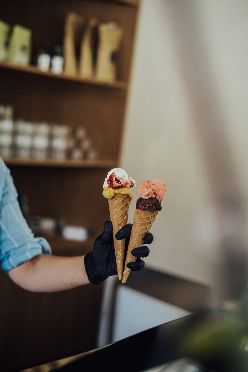 Two ice cream cones being served at the Bitterkoud counter